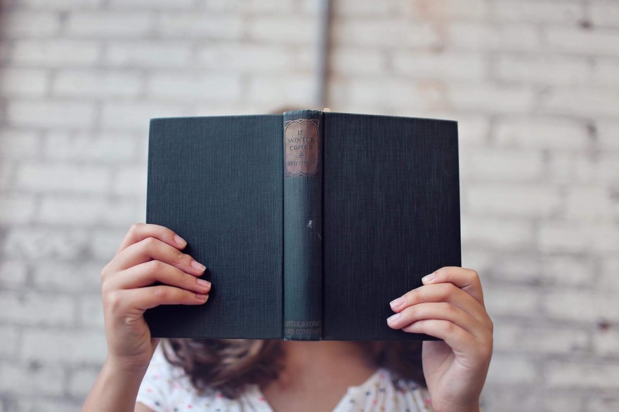 hiding behind book